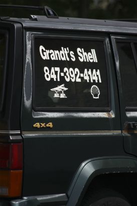 Grandt's Shell. Vinyl lettering on rear window of a vehicle.